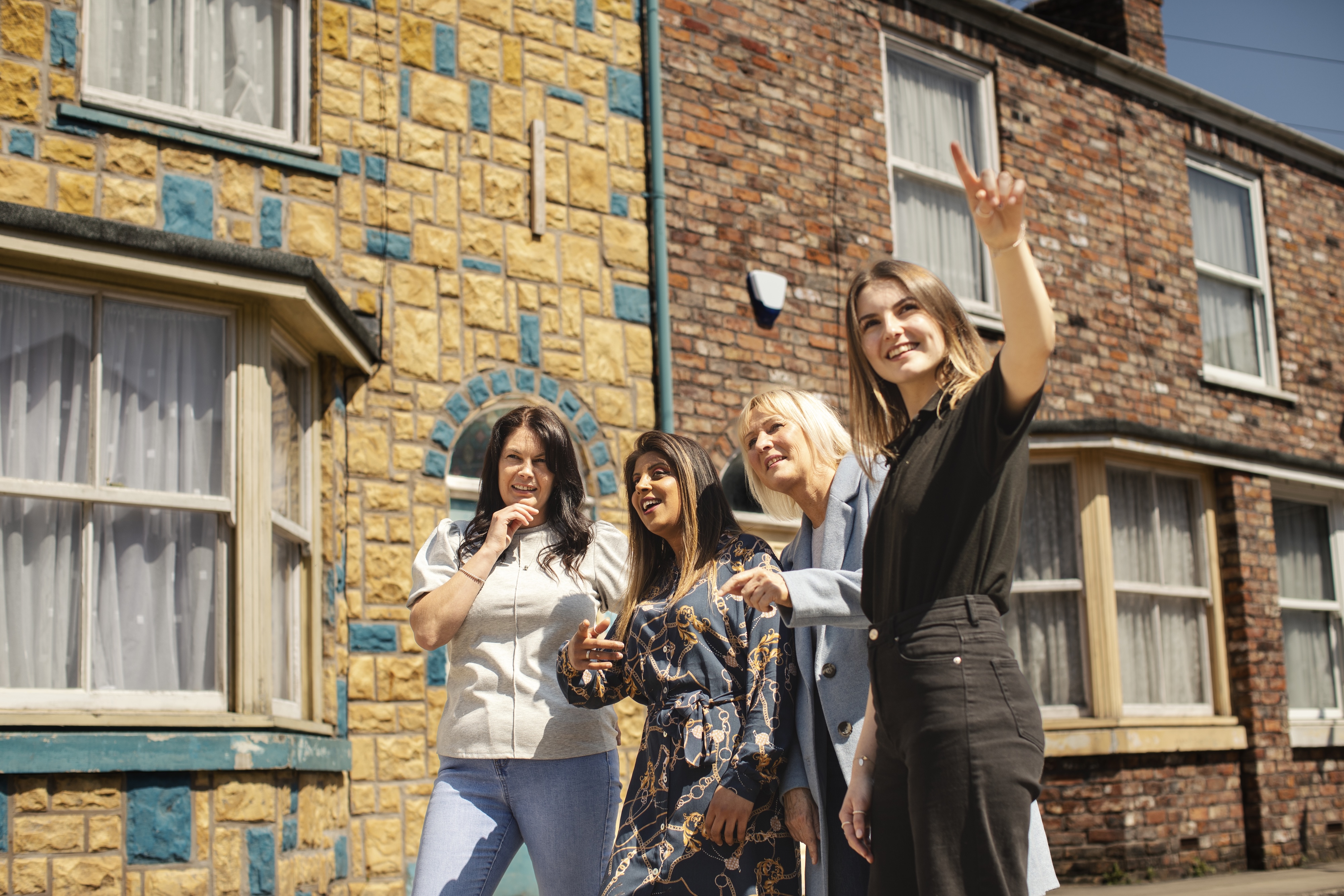 Visitors exploring Coronation Street during the behind-the-scenes guided tour in Manchester